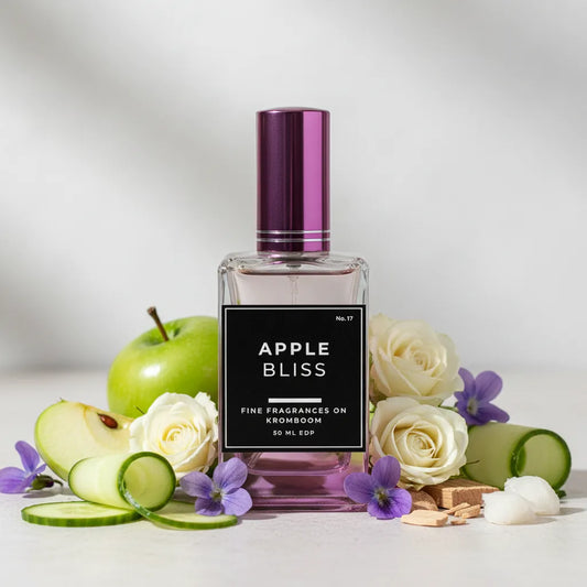 Perfume bottle labeled 'Apple Bliss' with apples, roses, and cucumbers on a light background