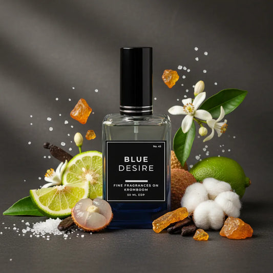 Perfume bottle labeled 'Blue Desire' surrounded by floral and fruit elements on a dark background