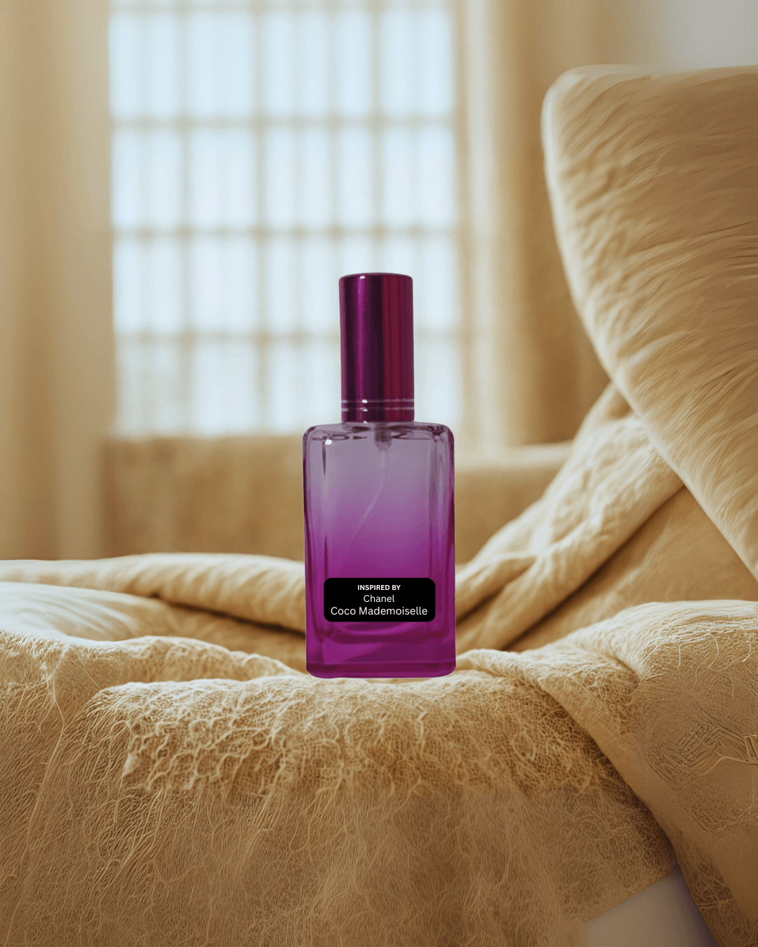 Chic women’s citrus floral perfume inspired by Coco Mademoiselle – Parisian Whisper by Fine Fragrances on Kromboom on a textured beige surface with a blurred window in the background