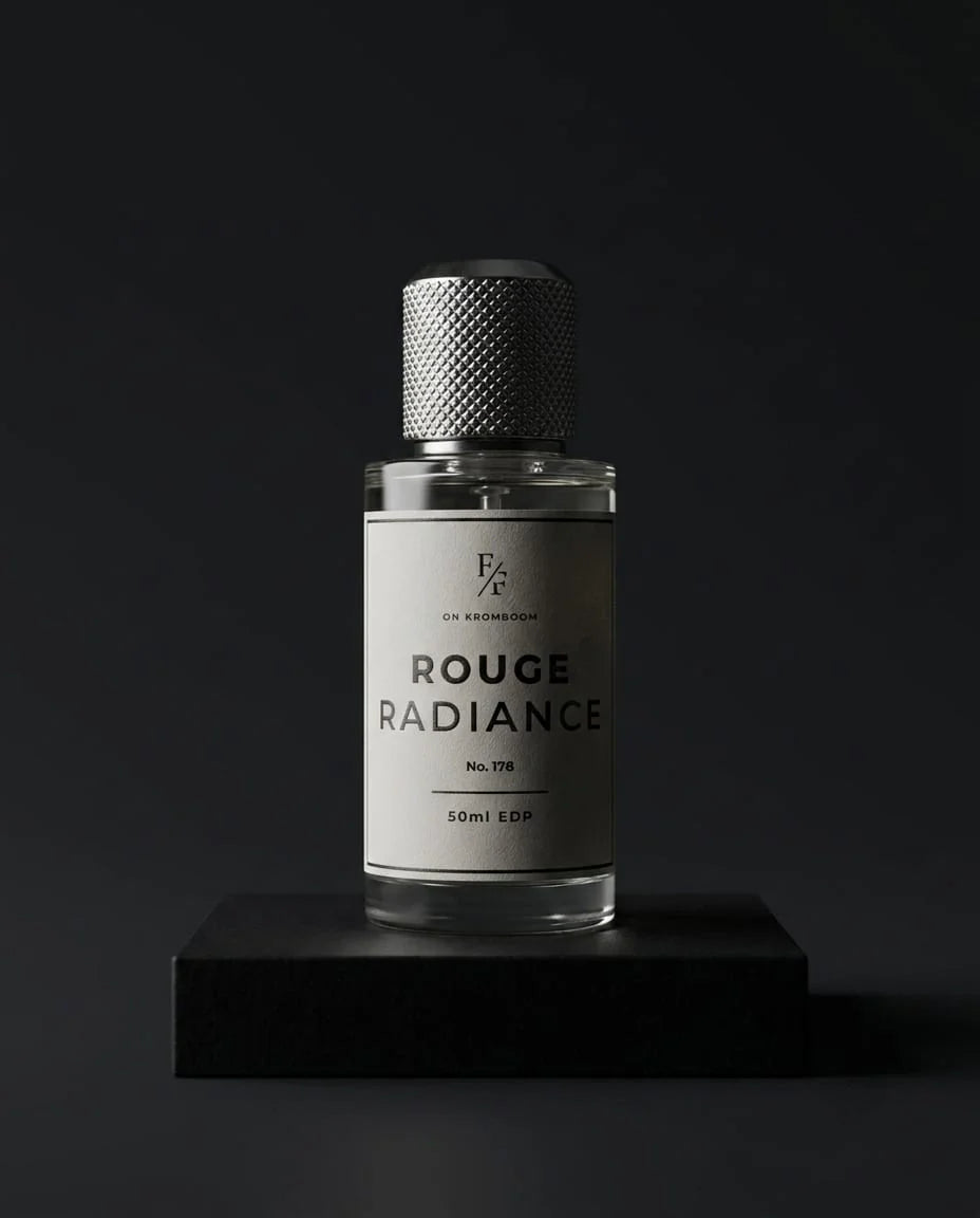A young couple holding and smelling a bottle of "Rouge radiance by Fine Fragrances on Kromboom" perfume