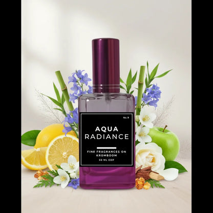 Perfume bottle labeled 'Aqua Radiance' surrounded by fruits and flowers on a light background