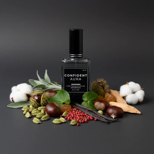 Perfume bottle labeled 'Confident Aura' surrounded by natural elements on a dark background