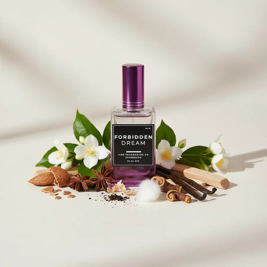 Perfume bottle labeled 'Forbidden Dream' surrounded by flowers and spices on a light background