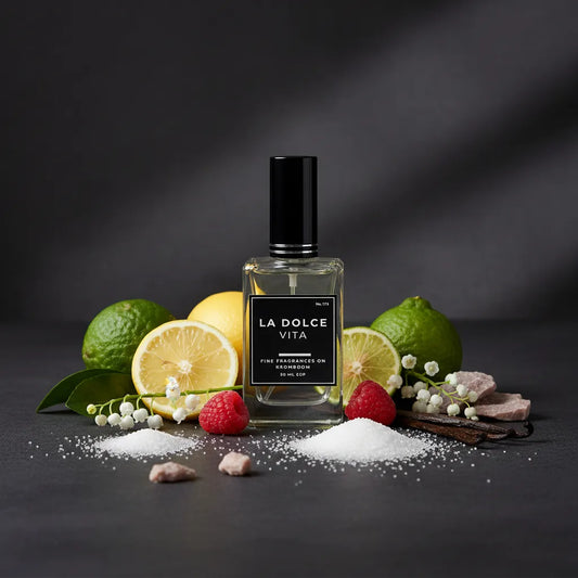 Perfume bottle labeled 'La Dolce Vita' surrounded by fruits and candies on a dark background