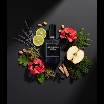 Perfume bottle labeled 'Legendary Aura' surrounded by flowers, fruits, and herbs on a dark background
