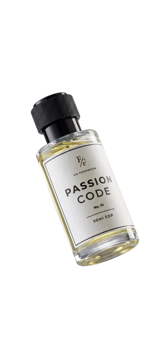 A 10ml clear glass bottle of passion code essential oil by On The Rocks, featuring a white label and a black ribbed cap, floating against a light gray gradient background.