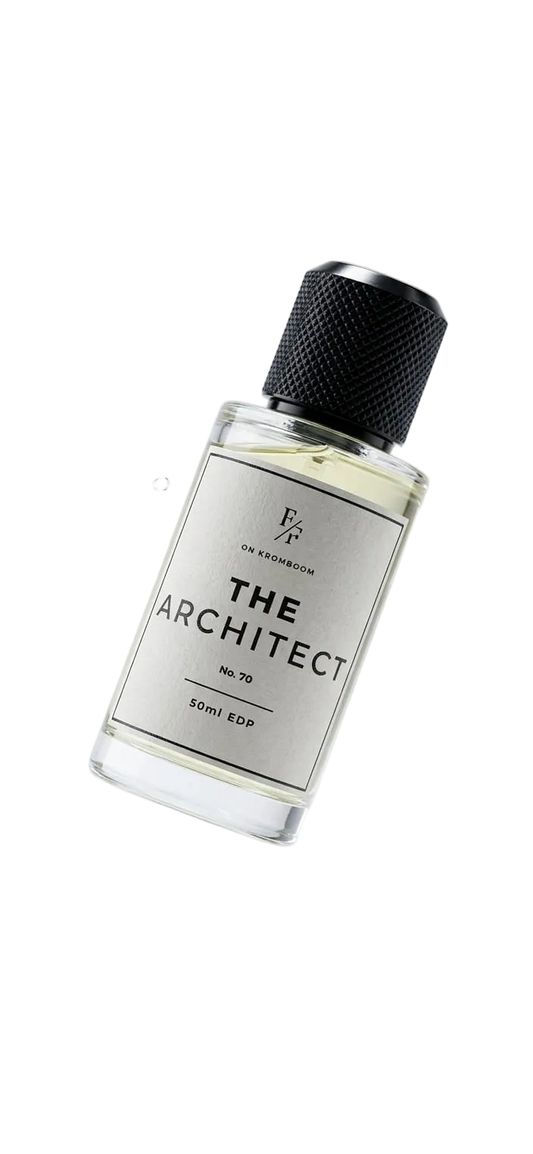 A clear glass bottle of 'The Architect' cologne by Entheistic Fragrance, featuring a white label and a textured black cap, shown floating against a light gray background with water droplets.