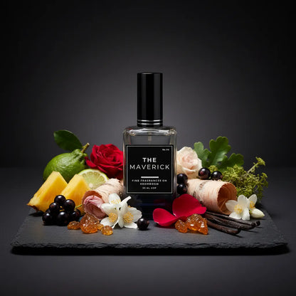 Perfume bottle labeled 'The Maverick' surrounded by flowers, fruits, and herbs on a dark background